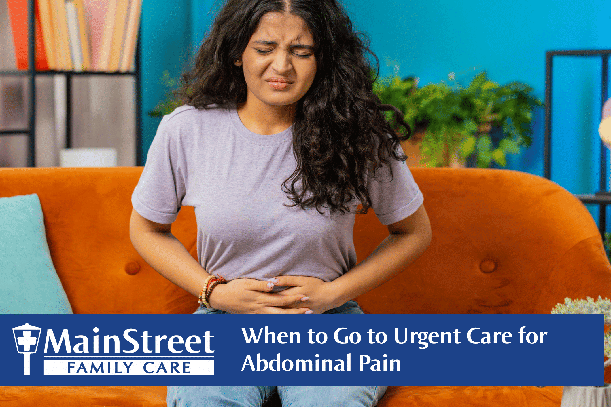 Woman on the couch holding her stomach with abdominal pain. Featured image for When to Go to Urgent Care for Abdominal Pain blog post.