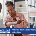 Woman at urgent care showing medical provider a rash on her arm. Featured image for When a Rash Needs Medical Attention